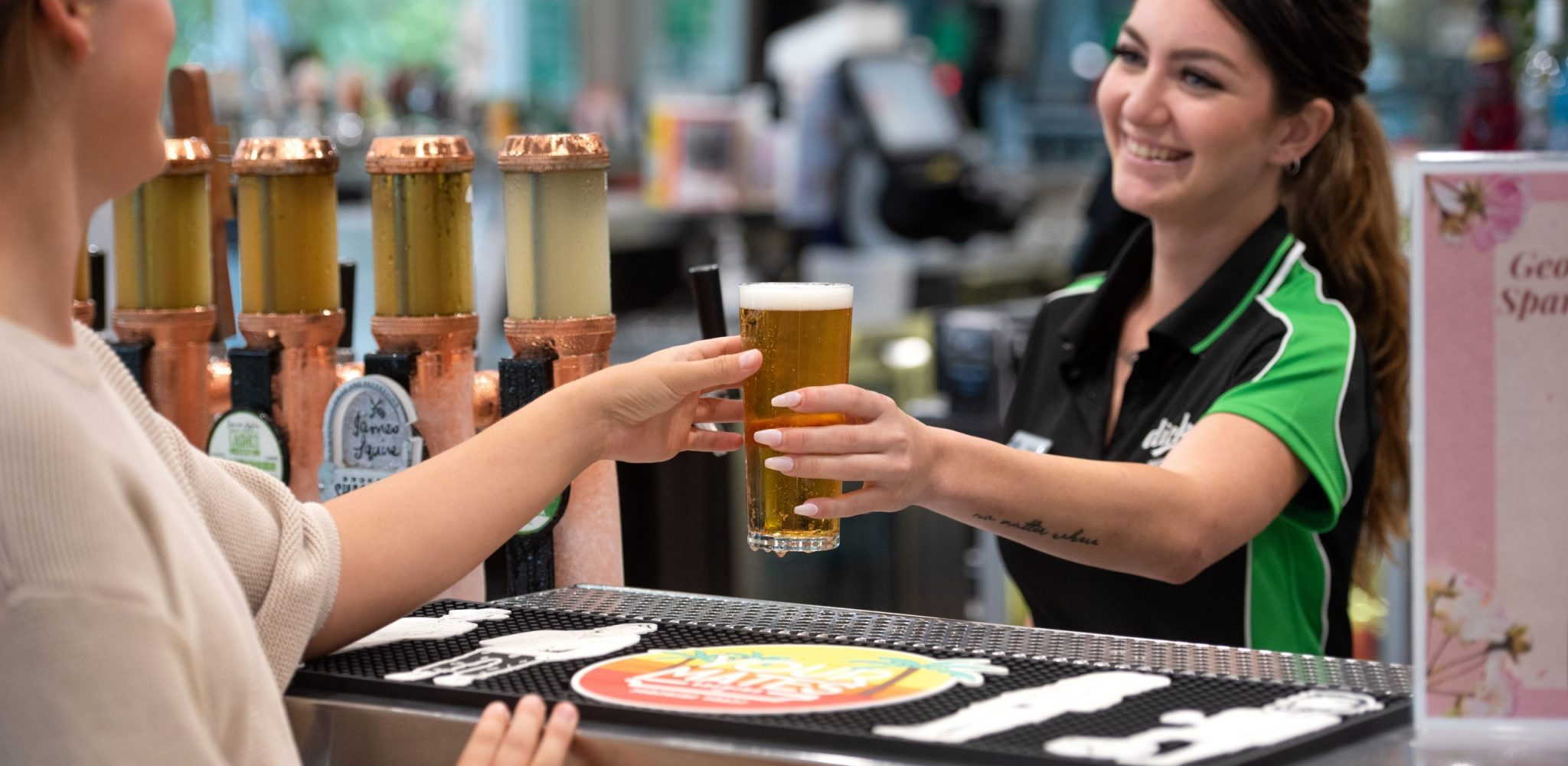 Happy club member being served a beer at the bar